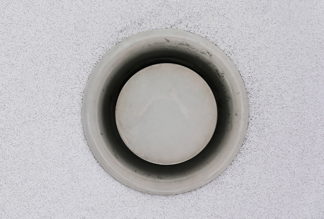 round vent in a white wall